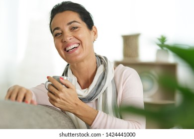 Attractive Older Woman Sat On The Sofa