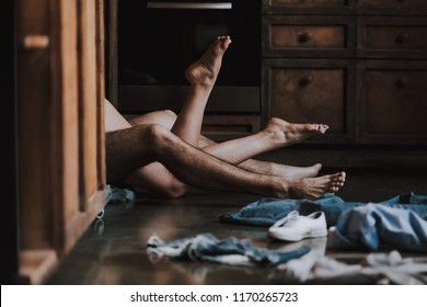 Attractive Passionate Couple Having Sex in Kitchen. Man and Woman Lying on the Floor in the Kitchen at Home and Having Sex. Love Concept. Romantic Date. Relationship. Husband and Wife.