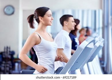 Attractive people on the treadmill - Powered by Shutterstock