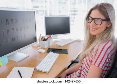 Attractive photo editor working on computer in a modern office