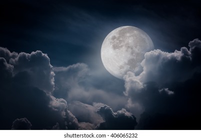 Attractive photo of a nighttime sky with clouds, bright full moon would make a great background. Nightly sky with large moon. Beautiful nature use as background. Outdoors. - Powered by Shutterstock