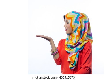 Attractive portrait of young muslim woman looking at her palm