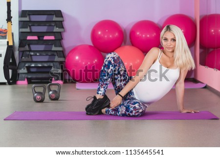Attractive pregnant woman's doing yoga in the gym with step aerobic, healthy lifestyle