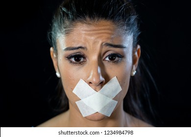 Attractive Scared Woman With Taped Mouth Making In Silence Abuse Censorship Me Too And Freedom Of Speech Concept Isolated On Black Background.