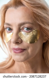 Attractive Senior Caucasian Woman Applying Medical Eye Patch And Smiling