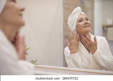 Attractive Senior Woman Browsing In The Mirror