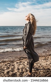 Attractive sexy sweden blonde in a romantic mood on a cool windy day by the lake - the wind ruffles her hair