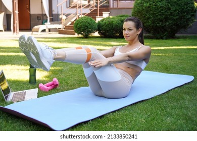 Attractive Slim Girl In Sportswear Is Doing Abs Exercise Outdoor. Healthy Lifestyle