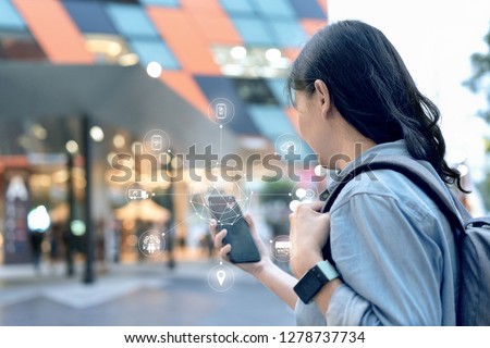 Attractive smart asian traveller woman use her smartphone to booking hotel in ecommerce website on omni channel platform. She can do every steps on only one mobile.