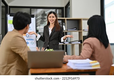 Attractive And Smart Young Asian Businesswoman Or Female Financial Analyst Presenting Her Financial Strategy To Board Members In The Meeting Room.