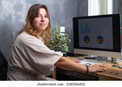 Attractive Smiling 25 Year Old Woman Working At Home On A Computer
