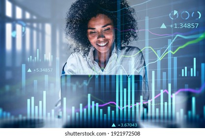 Attractive smiling African American business woman or stock trader analyzing stock graph chart using laptop, Portrait front view businesswoman. Buy or sell concept, double exposure , internet trading - Powered by Shutterstock