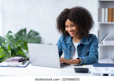 Attractive smiling African American businesswoman using laptop at office - Shutterstock ID 2195868555