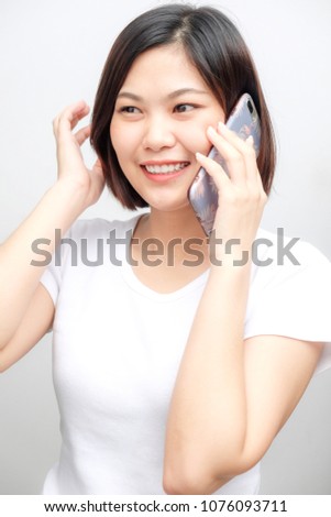 Attractive smiling asian beautiful business women talking smartphone on white background