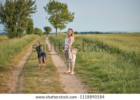 Attractive smiling blond woman with her two dogs