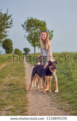 Attractive smiling blond woman with her two dogs