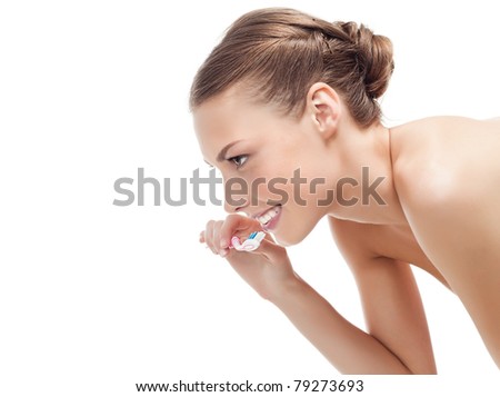 attractive smiling woman brushing her teeth on white background