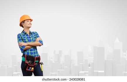 Attractive Smiling Woman Engineer Wearing Helmet And Tool Belt