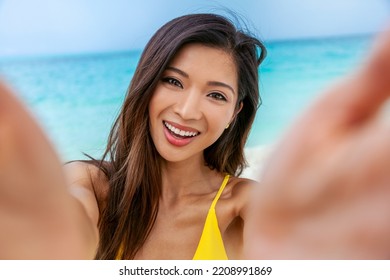 Attractive Smiling Young Asian Woman Happily Taking Selfie By Tropical Ocean Enjoying Luxury Outdoor Living On Vacation Bahamas