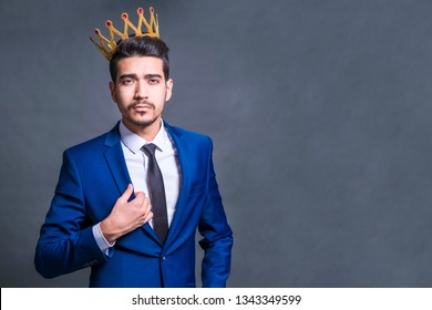 Attractive Smug Man With A Crown On His Head On A Gray Background