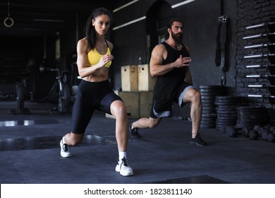 Attractive Sport Couple Doing Fitness At Gym.