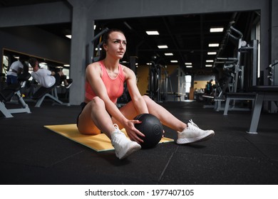 Attractive Sportswoman Doing Sit Ups With Medicine Ball