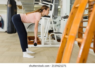 Attractive Sporty Girl Doing Leg And Glute Workout In Gym, Performing Romanian Deadlift With Dumbbells. Concept Of Weight Training For Women