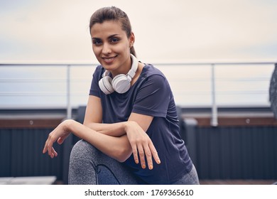 Attractive Sporty Lady In Shirt Looking At Camera And Smiling