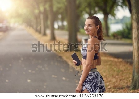 Attractive sporty woman with her cell phone