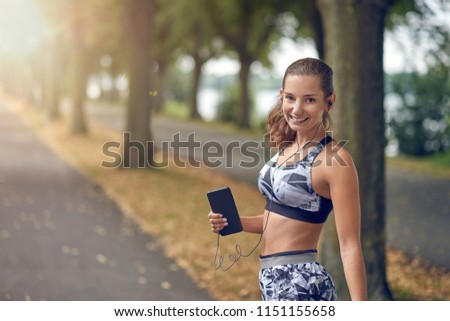 Similar – Attractive sporty woman with her cell phone