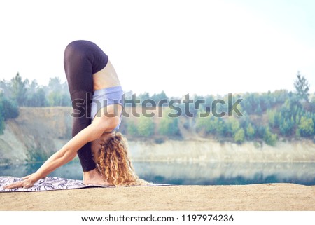 Attractive sporty woman or model practicing yoga outdoors. Yogi girl working out. Concept love yoga. Concept love morning