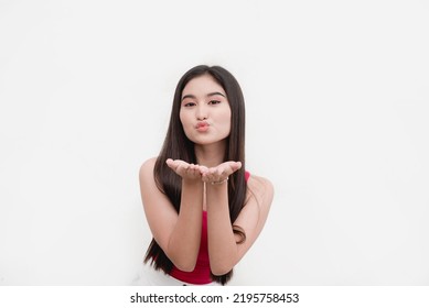 An Attractive Squared Jawed Female Teenager Blows A Kiss With Both Hands. Showing Flirty And Fun Behavior. Dating Concept.