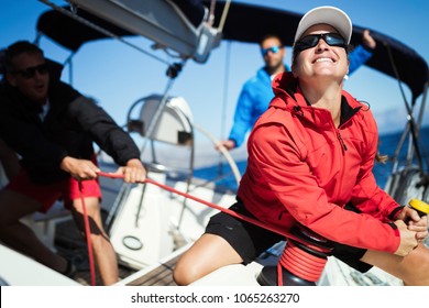 Attractive strong woman sailing with her boat - Shutterstock ID 1065263270
