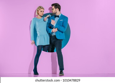 Attractive Stylish Couple Stepping Through Aperture On Purple