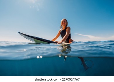 Attractive Surf Girl Sitting On Surfboard Stock Photo