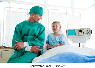 Attractive Surgeon Explaining A Surgery To A Child Patient In A Hospital