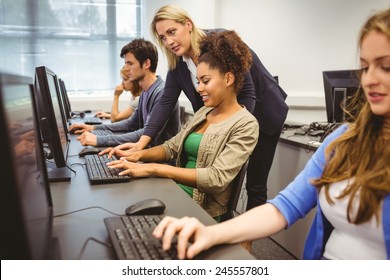 Attractive Teacher Helping Her Student In Computer Class At The University