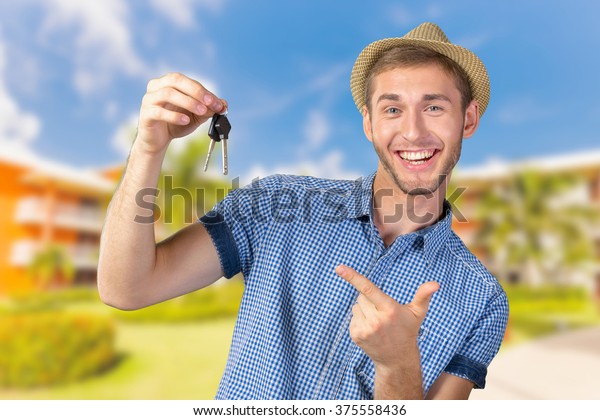 Attractive teenage boy\
holding car keys