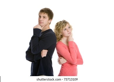 Attractive Teenage Couple Standing Back To Back Thinking In Studio With White Background