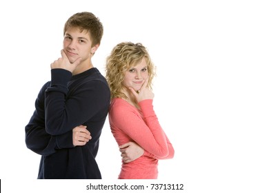 Attractive Teenage Couple Standing Back To Back On White Background In Studio