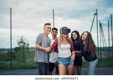 Attractive teenagers on playground. Girl with VR glasses. - Powered by Shutterstock