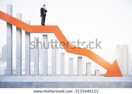 Attractive tiny european business man standing and balancing on abstract red downward chart arrow on light city background with mock up place. Down, drop, finance and crisis concept