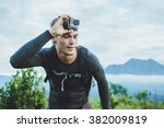 Attractive Traveler with Go PrO camera on his hand against the Batur volcano from Kintamani, Bali, Indonesia