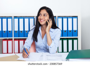 Attractive Turkish Businesswoman With Phone At Office