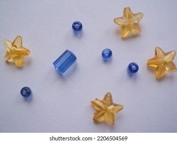 Attractive Wallpaper Of Crystal Shapes Of Stars And Rounds. There Are Golden And Bluish Garnish And Attractive Patterns On The Background.