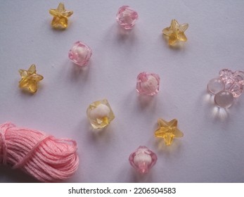 Attractive Wallpaper Of Crystal Shapes Of Stars And Rounds. There Are Golden And Pinkish Garnishes And Attractive Patterns On The Background.