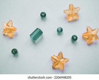 Attractive Wallpaper Of Crystal Shapes Of Stars And Rounds. There Are Golden And Bluish Garnish And Attractive Patterns On The Background.