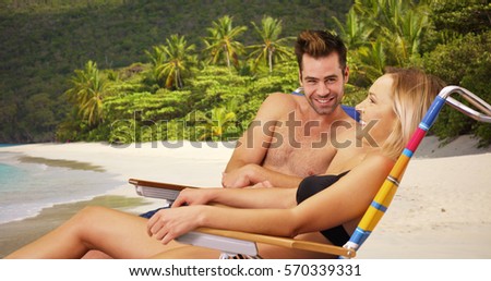 Attractive white millennial couple relaxing at the beach