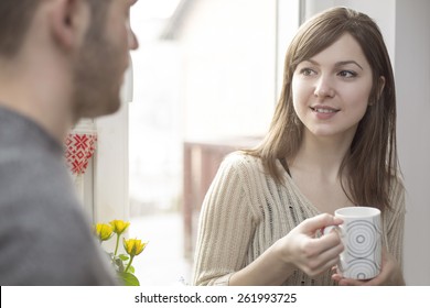 Attractive Wife Talking With Her Husband By The Window