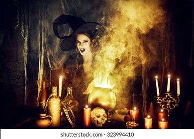 Attractive witch conjures in the wizarding lair. Fairytales. Halloween.